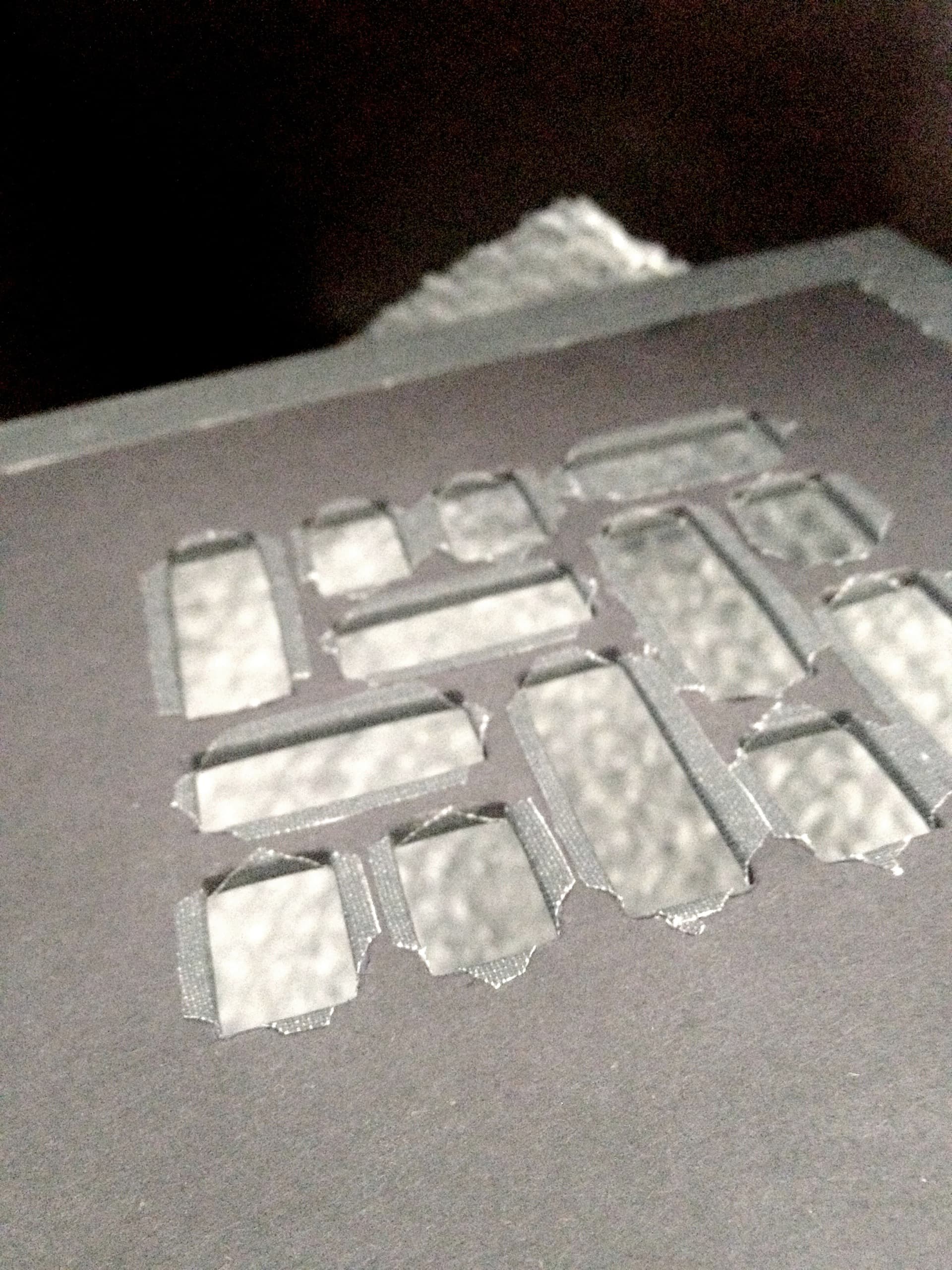 Failed Mosaic cover prototype with damaged die-cut edges