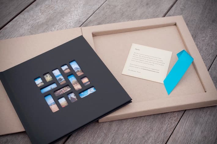 Mosaic book beside its open box, note, and ribbon