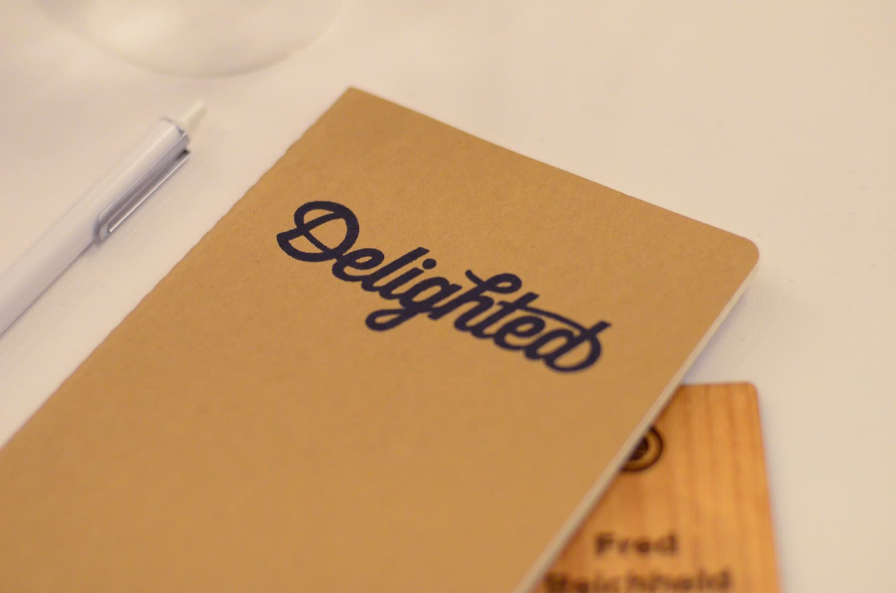 Delighted branded notebook at a fireside chat
